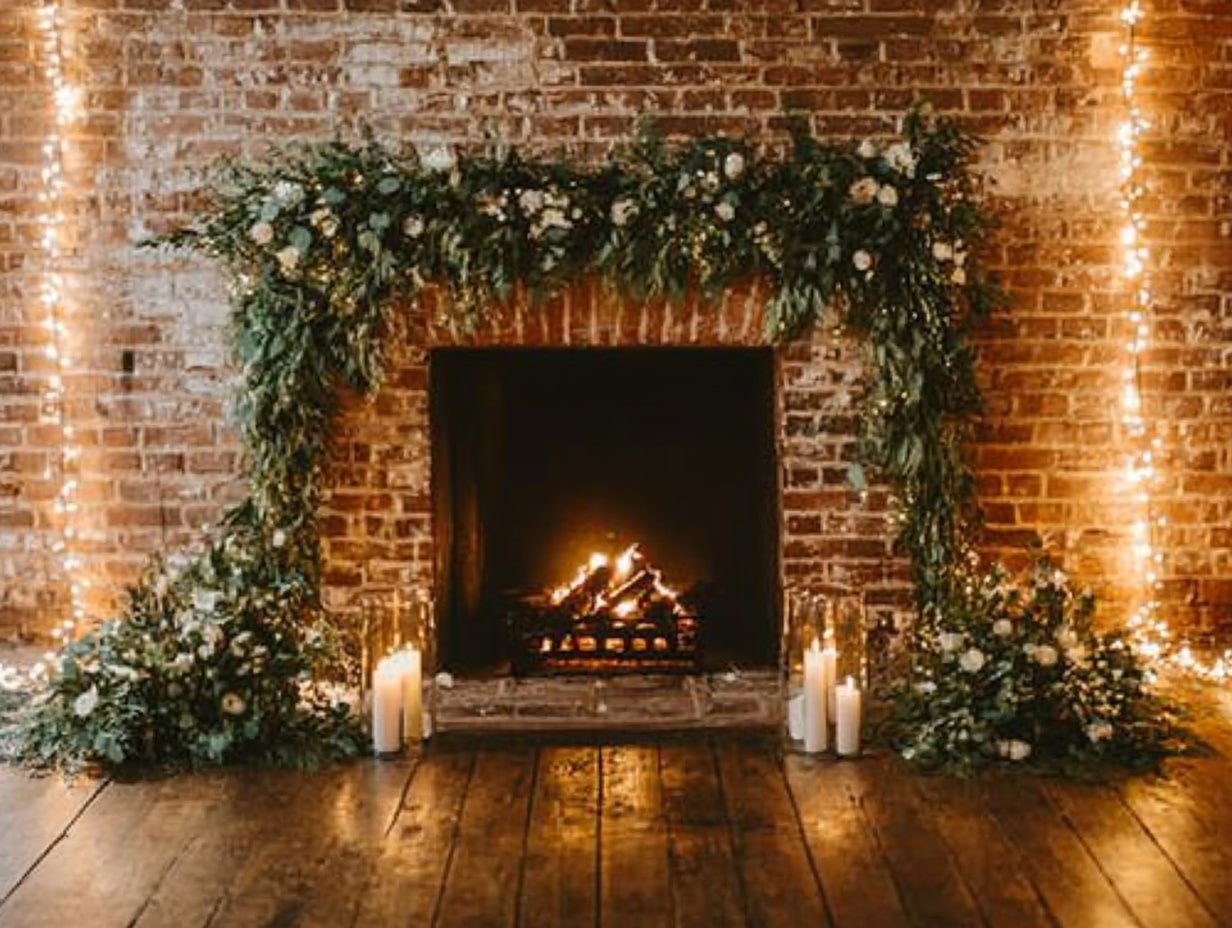 a Romantic Fireplace Backdrop With Winter Greenery